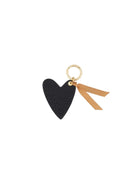 Zusss sleutelhanger in de vorm van een zwart hart met goudkleurige details.
